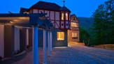 A view of a mini bavarian style village, with pink orange and red house lit up at night