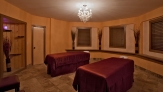 two red massage tables in an a natural orange octagonal room