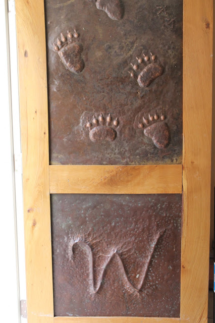 Copper door with bear footprints made at Fenton Inn VA 