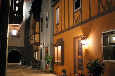 Fenton Inn at night with copper shigles above window tops and copper pots with hibiscus flowers