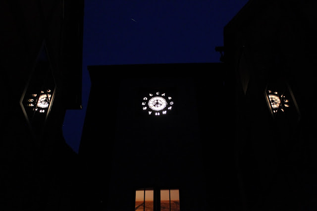 zodiac simbols on a clock tower with reflection