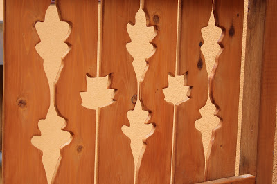 custom wooden railing with oak and poplar leaves 