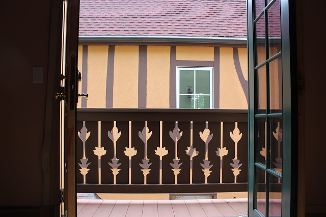 cantilevered balcony with wooden railing