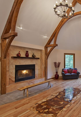 Grand lobby with tall white sloped ceiling. Large tan rustic beams are curved and a round chandelier hanging above